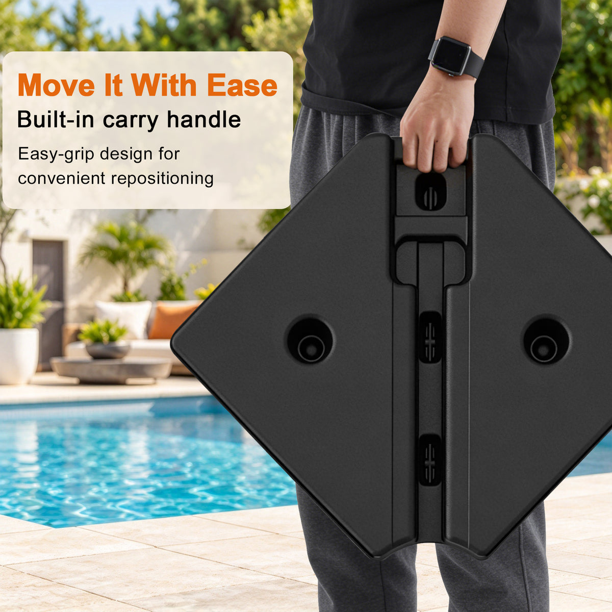 Person carrying a cantilever umbrella base weight section by its built-in handle, showing an easy-grip design for convenient repositioning - Sunshade